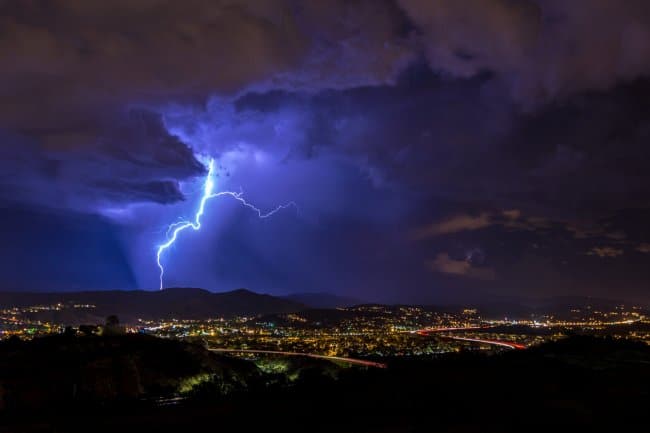 lightning hitting mountain in background